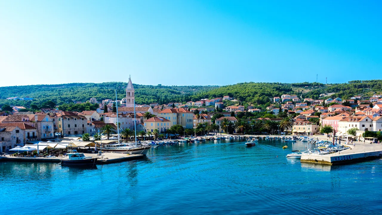 The harbour and parish church bell tower in Supetar