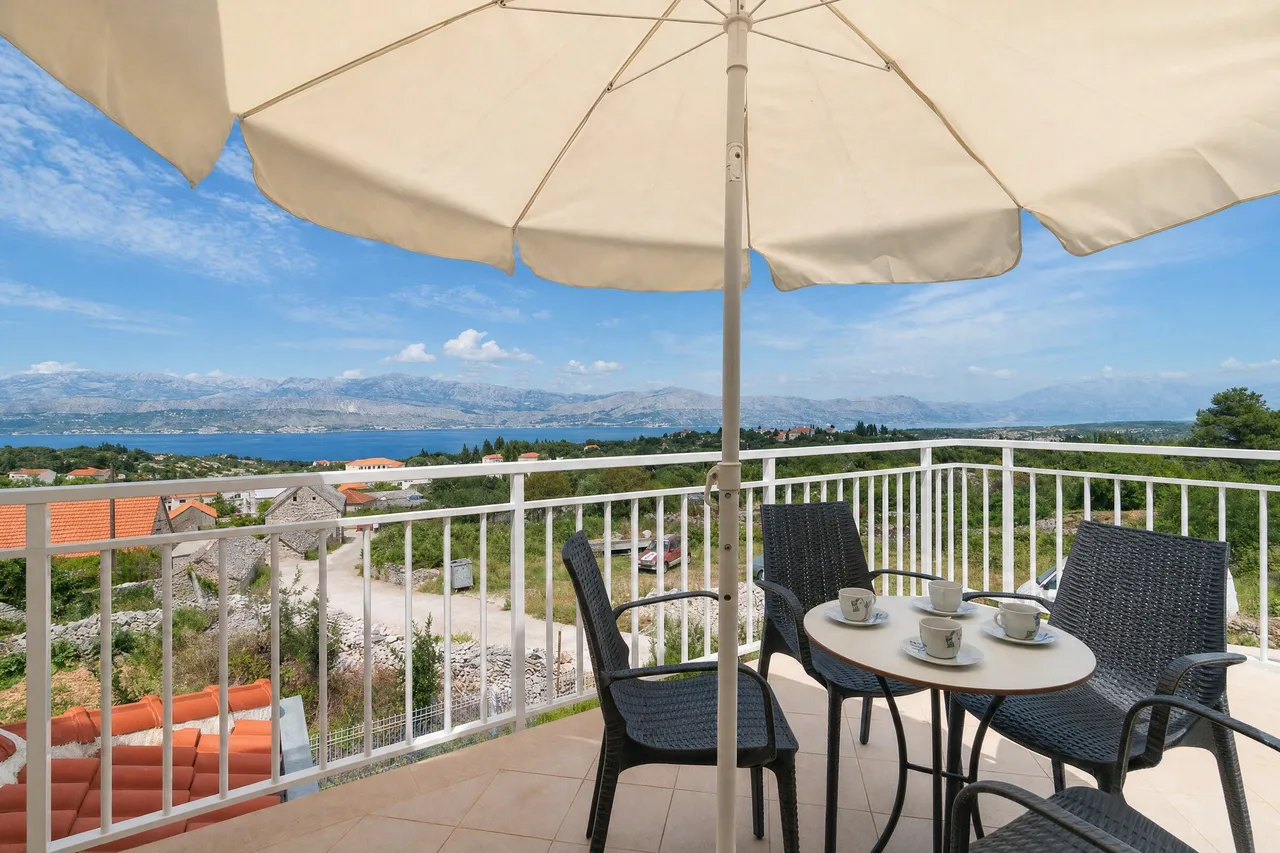Terrace with a parasol and sea view